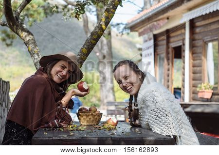 Two Contryside Friends Eating Apple And Smile