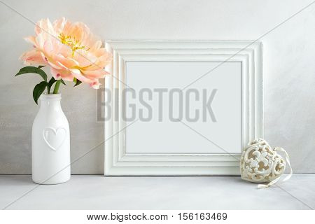 White landscape frame mockup with a peony & heart beside the frame overlay your quote promotion headline or design great for small businesses lifestyle bloggers and social media campaigns