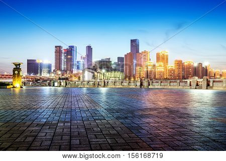 cityscape and skyline of downtown near water of chongqing at night