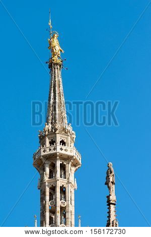 Madonnina gilded copper statue of the Virgin Mary (1774) on the main spire of Duomo di Milano (Milan Cathedral 1418-1577). Lombardy Italy