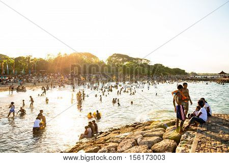 Sanur, Bali Indonesia - April 21, 2013 - Lots of people on the beach enjoy nice weather