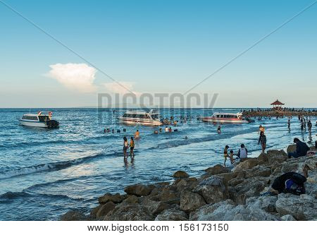 Sanur, Bali Indonesia - April 21, 2013 - Lots of people on the beach enjoy nice weather