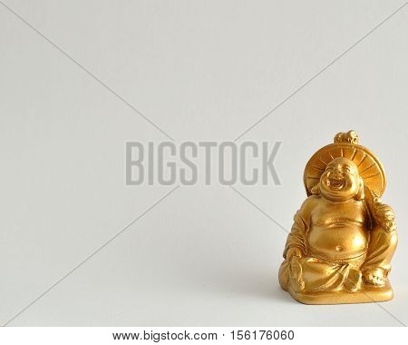 Figurine of a laughing and cheerful golden Buddha