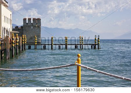 Wooden jetty for mooring motorboats on the Garda lake