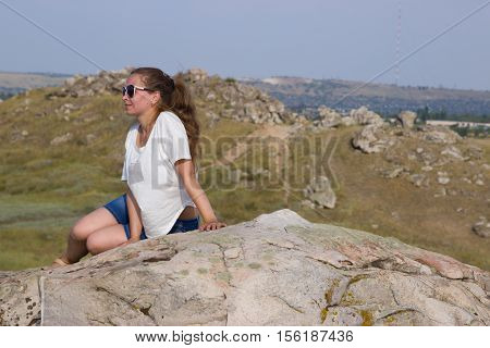 Girl on a mountain on the background of the steppe. Nature Monument -Kamyshinskye Mountain Ears. Volgograd region Russia