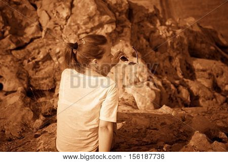 Girl on a hill in the desert. Ordinary people. Effect - Sepia. Nature Monument -Kamyshinskye Mountain Ears. Volgograd region Russia