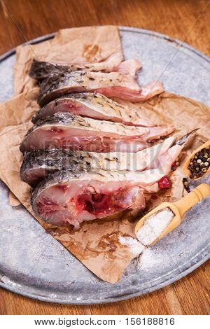 some pieces of fresh raw fish with salt and pepper