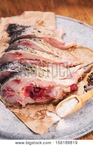 some pieces of fresh raw fish with salt and pepper