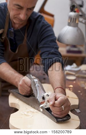 Artisan Lutemaker Working A Violin In His Workshop