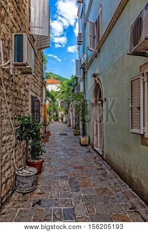 BUDVA, MONTENEGRO - JULY 18: Picturesque narrow street, on July 18, 2014 in Budva, Montenegro. Budva among the oldest urban settlements of the Adriatic coast, a UNESCO World Heritage Site.