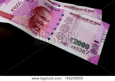 The brand new Indian currency notes of 2000 rupees isolated on black. These have been introduced as part of a drive to curb black money