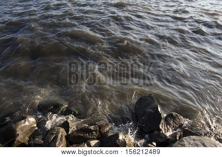 Lumpy Caspian Sea on Sunset. Waves and Rocks