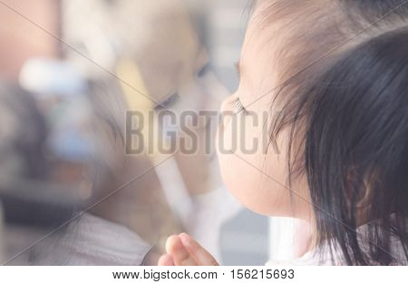 Asian kid to kissing. Child playing at home. imagination concept