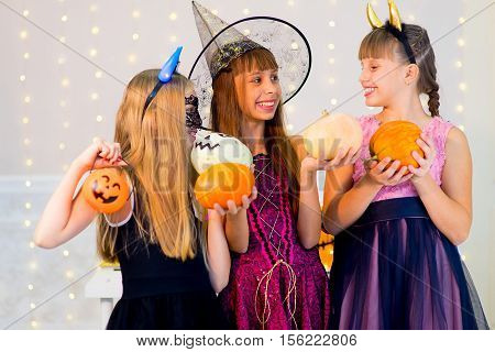 Happy Group Of Teenagers In Halloween Costumes Posing On Camera