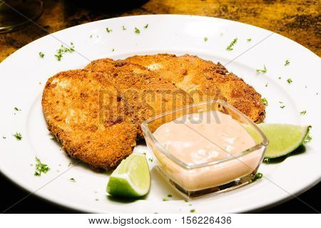 Breaded eggplant with pink sauce and lemon