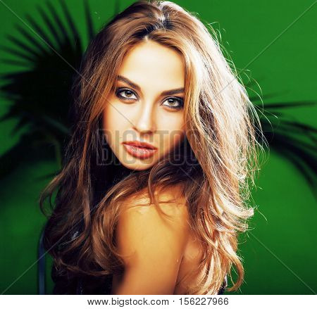 young cute blonde woman on green palm background smiling happy, lifestyle peole concept close up