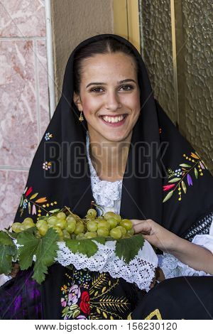QUARTU S.E. ITALY - September 17, 2016: Parade of Sardinian costumes and floats for the grape festival in honor of the celebration of St. Helena. - Sardinia - portrait of a beautiful girl in traditional Sardinian costume