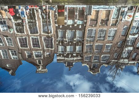 Typical Amsterdam buildings reflecting in the channel