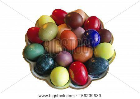 Rustic Easter colored eggs in the dish on white background
