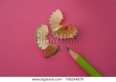 pencil and shaving on pink paper background