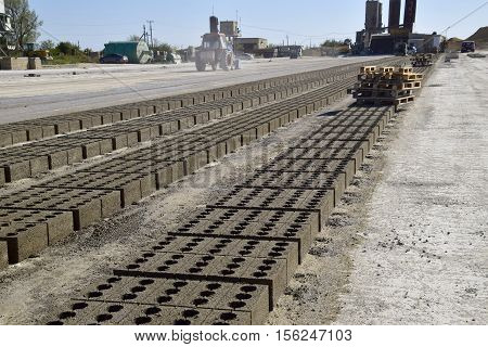 Cinder Blocks Lie On The Ground And Dried. On Cinder Block Production Plant.