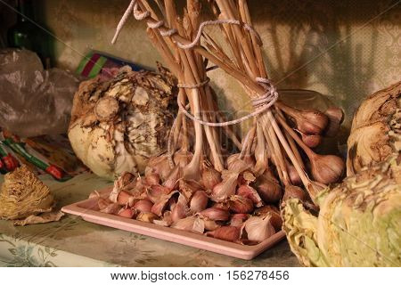 Group of garlic bulb and cabbages on the shelf