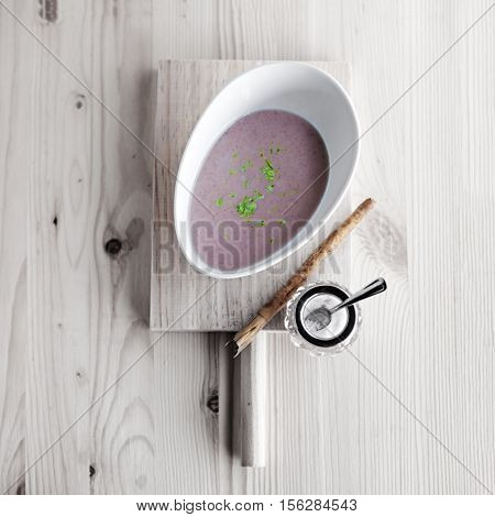 Chestnut soup with milk and cinnamon on white board