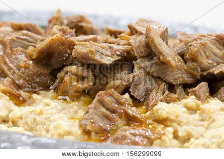 Lamb stew served on a bed of baked eggplant called Hunkar Begendi close up.