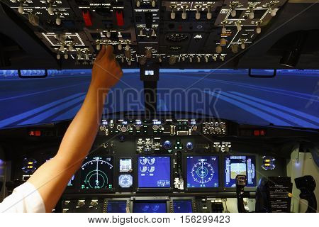 Hand control switch on top board of pilot room in flight simulator