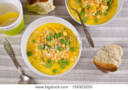 Soup with pasta and vegetables on textile background. Selective focus.