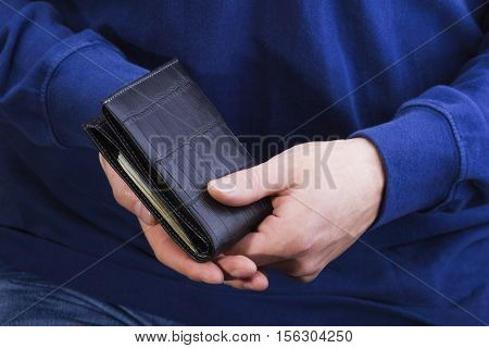 man holding a leather wallet with money