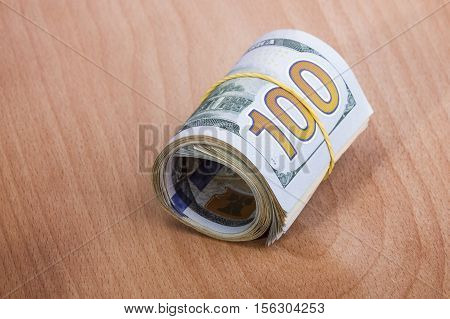 hundred-dollar bills rolled up with a rubber band