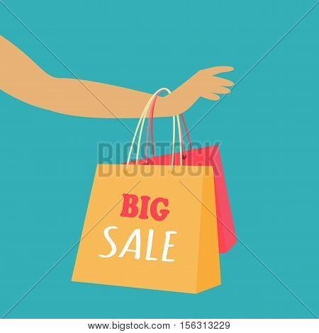 Big sale in woman s clothing store. Color shopping paper bags hanging on a female hand flat vector illustration on blue background. Black friday. For seasonal sales and discounts promotions design