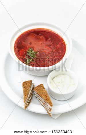 Ukrainian national dish. Borsch (soup cooked with beets and cabbage) served with bacon and sour cream.