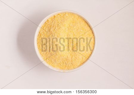 Corn Couscous into a bowl isolated on white background. Cuscus