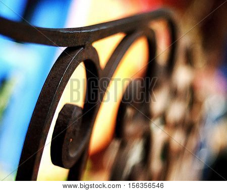 An colorful abstract image of iron fencing.