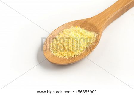 Corn Couscous into a spoon isolated on white background. Cuscus
