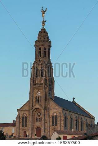 Church of Saint Michael in Saint-Michel-Mont-Mercure France with a large figure of the Archangel Michael at the top of the tower