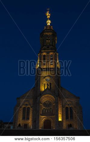 Church of Saint Michael in Saint-Michel-Mont-Mercure France with a large figure of the Archangel Michael at the top of the tower