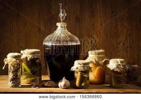Homemade Wine In Larder With Vegetables Jars