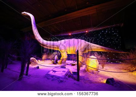 MOSCOW - JAN 30, 2015: Diplodocus dinosaur at show of dinosaurs in pavillion of VDNKH, text translation - omeyzavr yungans