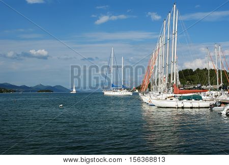Nidri GREECE May 11 2013: Landscape with blue harbour green coast mountains and yachts in Ionian sea Greece.