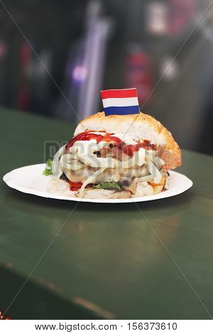 Netherlandish or dutch fish burger sandwich with fresh hering onion ketchup and mayonnaise. Street food or unhealthy food concept