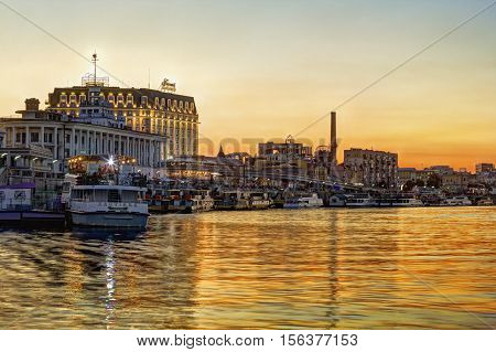 Kiev Ukraine - August 9 2016: View on the river bank of Poshtova Square and River Station at sunset. Tourists like to take a boat here and have an excursion.