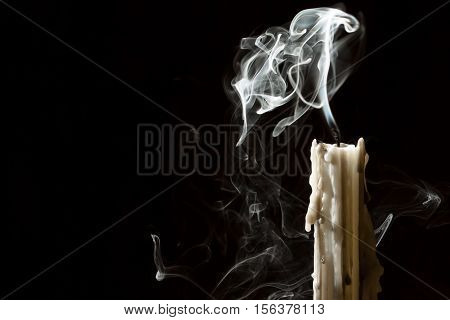 Candle blow off with smoke on black background