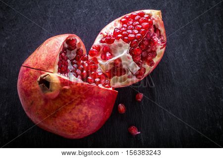 Fresh pomegranate placed on a stone plate
