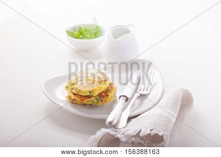 Healthy vegetarian zucchini fritters served on the table