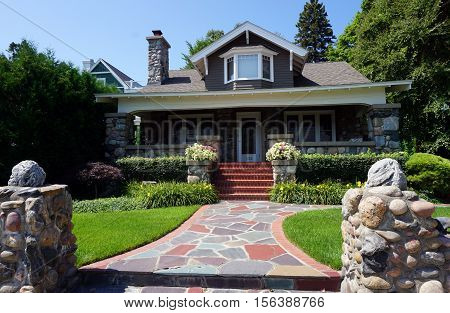 HARBOR SPRINGS, MICHIGAN / UNITED STATES - AUGUST 3, 2016: An elegant home made of stone and brick, across from the Zorn Park Beach in Harbor Springs.