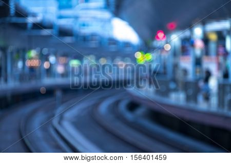 Blurry image of high-speed bullet train station in evening