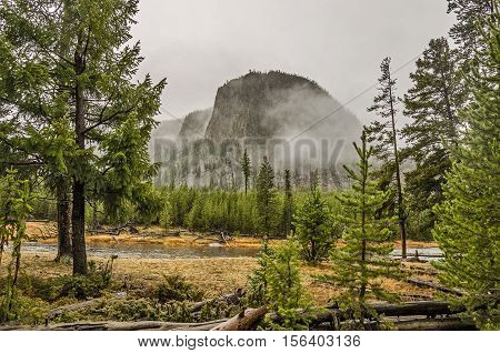 Mountain emerging from a morning fog in Yellowstone National Park